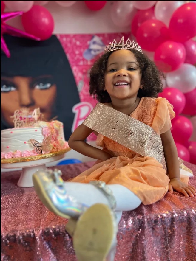 Birthday girl in a crown celebrating at her classroom party