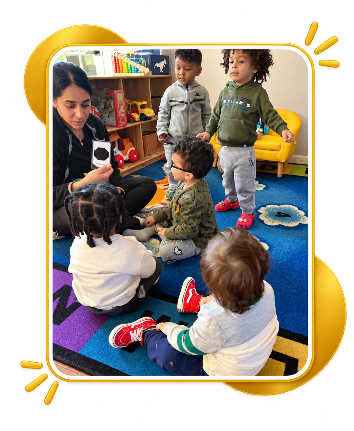 Teacher and children gathered for a classroom activity at Guardian Angels Childcare